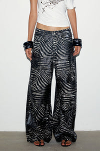 Front view of the Sable Jeans, low-rise baggy zebra-print jeans, worn with the Fiora Top