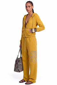 Model wearing the Monroe Sweatpants and Monroe Hoodie set in mustard yellow